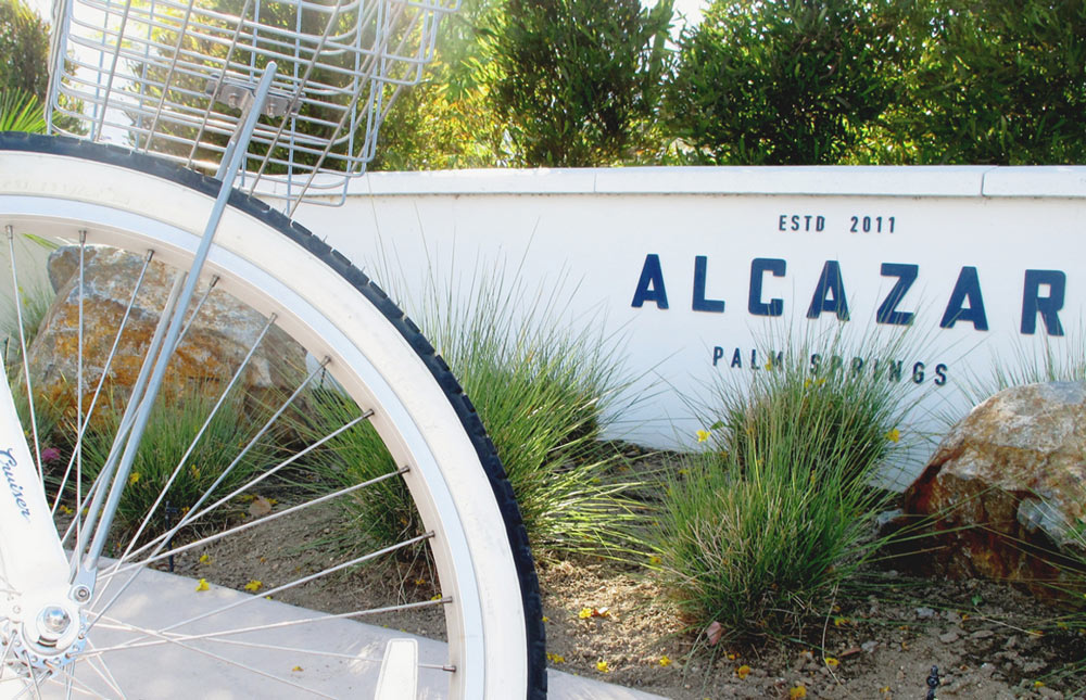 Alcazar_Palm_springs_botique-Bicycle tire and Alcazar Name on Wall