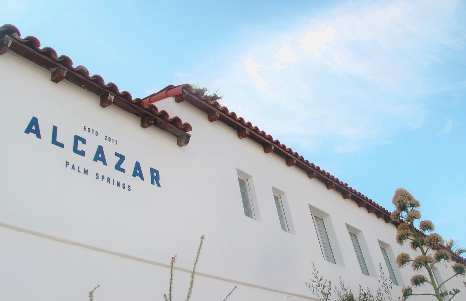 Alcazar Hotel with sky and logo